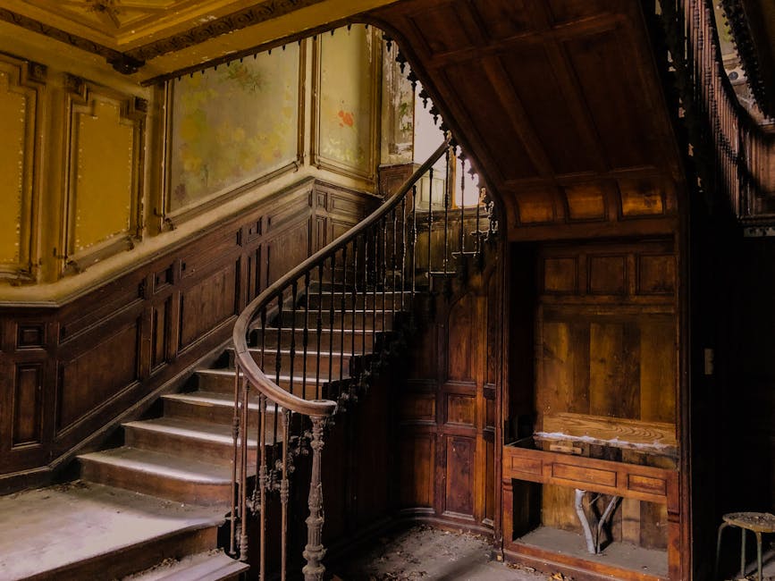 A luxurious, ornately decorated interior room with classic furniture and numerous framed paintings and mirrors on the walls. The space features a polished wooden floor, a decorative ceiling with a cha